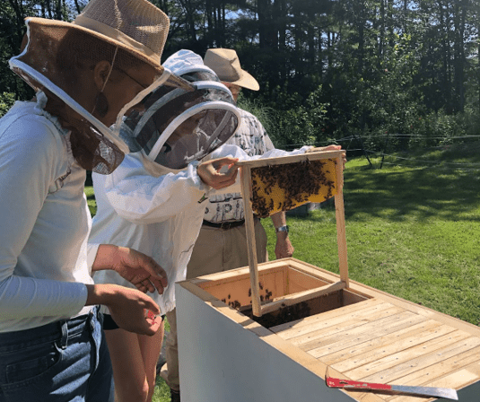 Meghan Peterson learning beekeeping skills